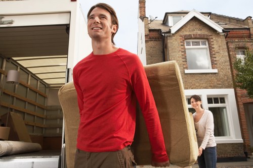 Professional movers preparing furniture for transport
