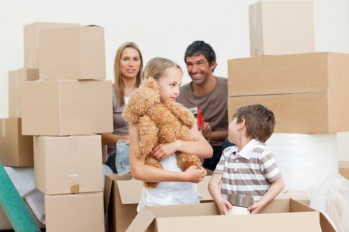 Professional movers handling office furniture during Poplar relocation